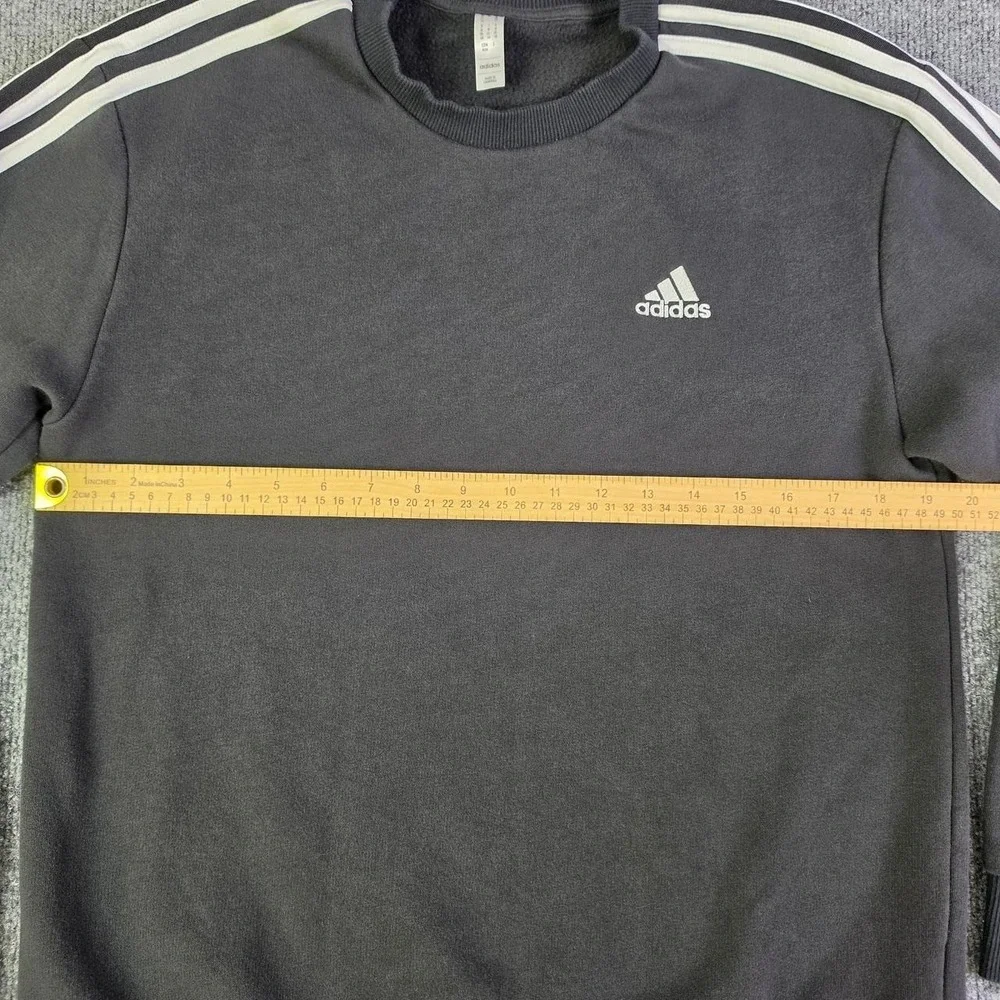 Adidas black crewneck sweatshirt with white stripes on sleeves, size M